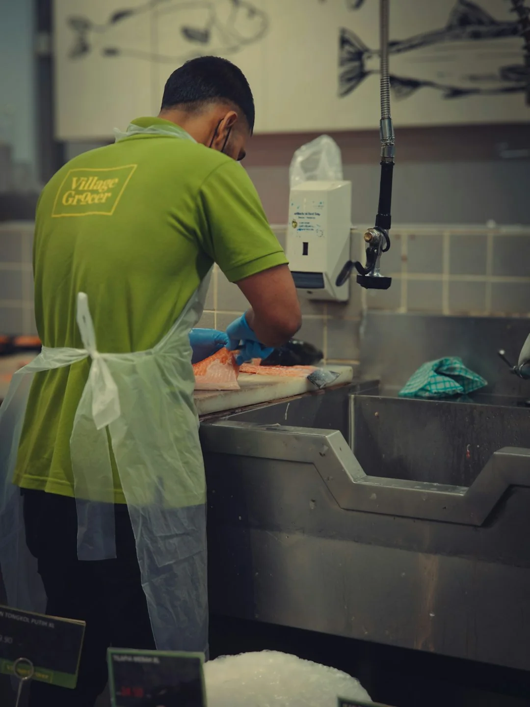 services-01 An adult male cleaning a glass window indoors, focusing on household chores and cleanliness.